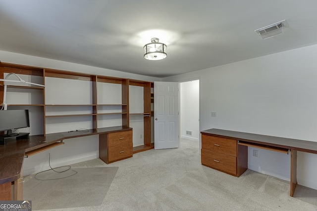 office featuring built in desk and light carpet