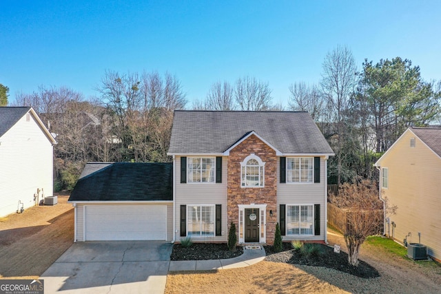 colonial inspired home with cooling unit and a garage