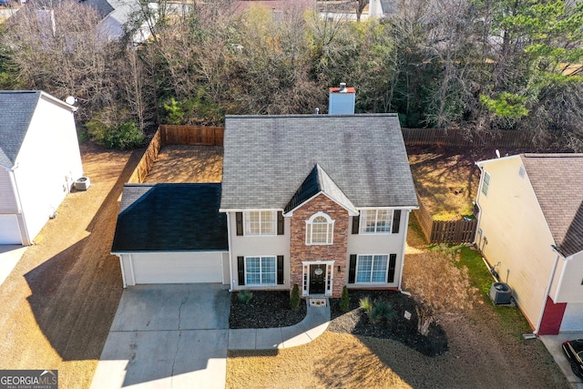 view of front of property featuring central AC and a garage