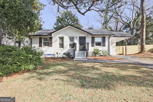 single story home featuring a carport and a front lawn