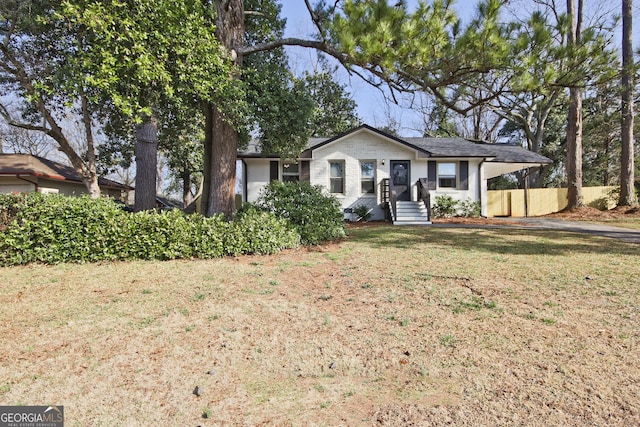 ranch-style home featuring a front yard