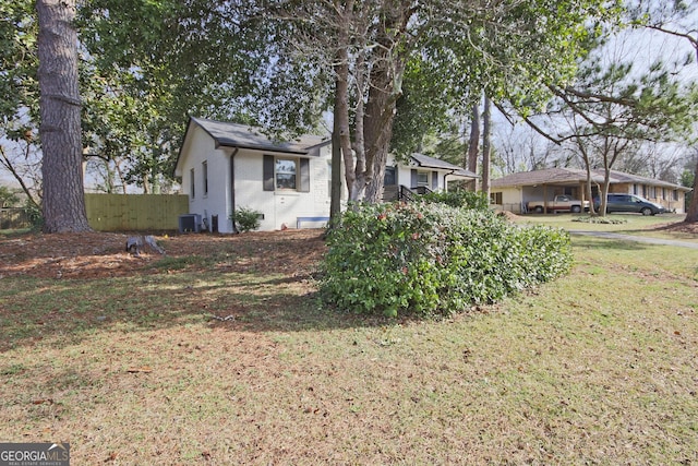 exterior space with cooling unit and a front yard