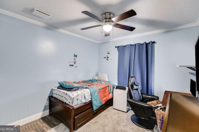 bedroom with ornamental molding, wood-type flooring, a textured ceiling, and ceiling fan