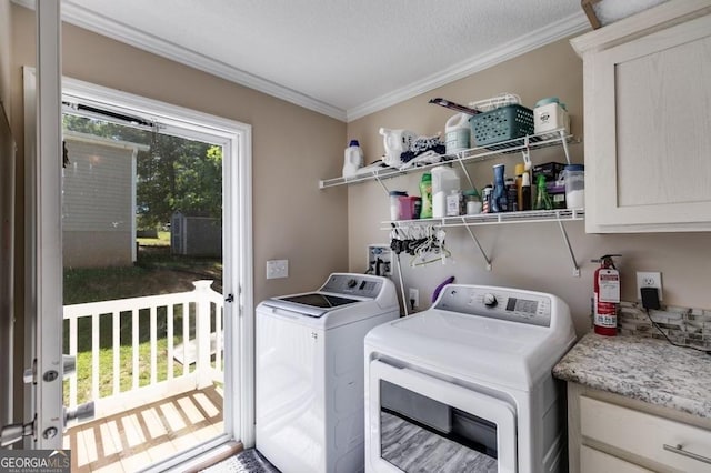 laundry room with crown molding and washer and clothes dryer