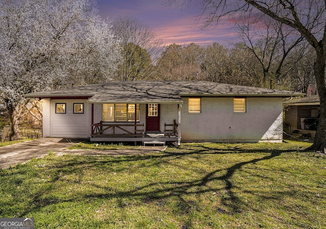 view of front of house with brick siding and a front yard