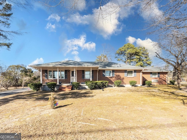 single story home with a front lawn and a porch