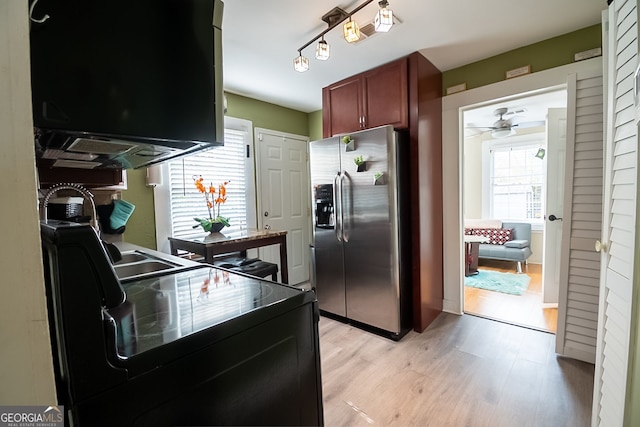 kitchen with rail lighting, sink, ceiling fan, light hardwood / wood-style floors, and stainless steel refrigerator with ice dispenser