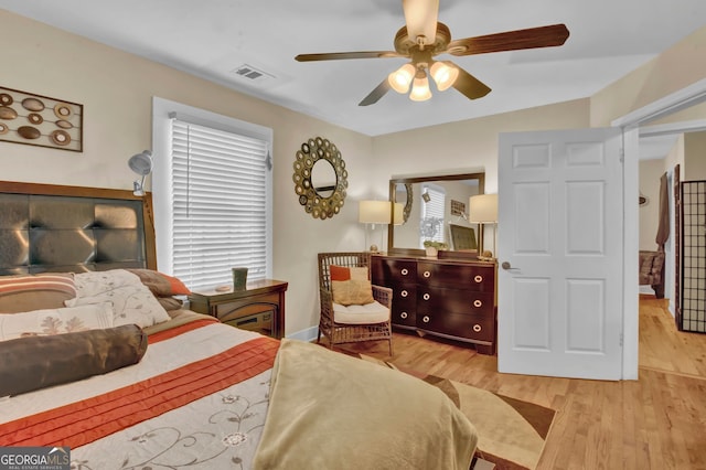 bedroom with ceiling fan and light wood-type flooring