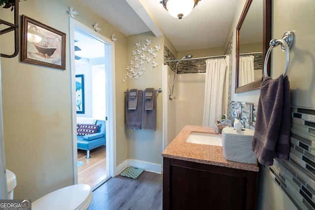 bathroom featuring vanity, hardwood / wood-style flooring, a shower with curtain, and toilet