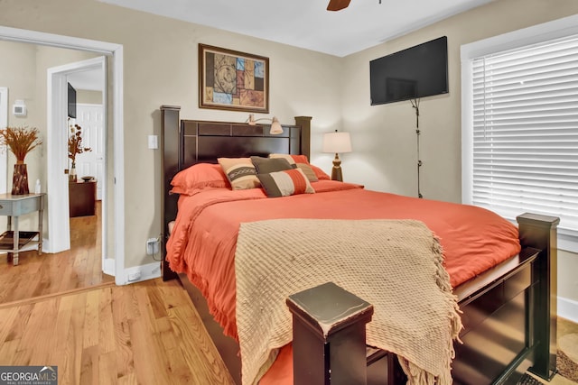 bedroom with ceiling fan and light hardwood / wood-style flooring