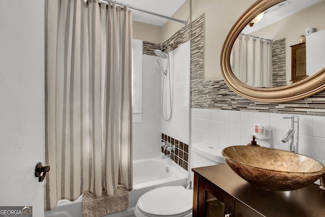 full bathroom featuring toilet, tasteful backsplash, shower / tub combo, tile walls, and vanity