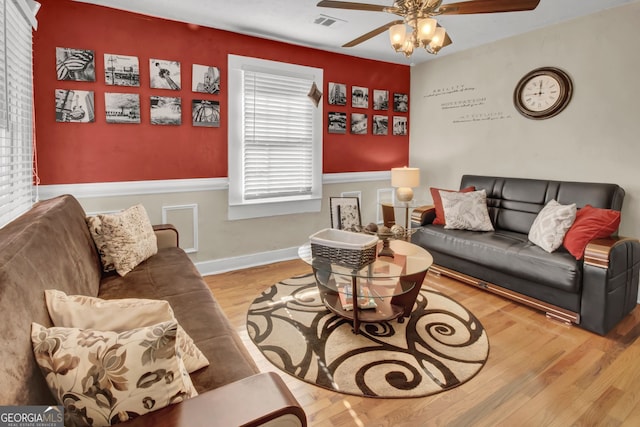 living room with ceiling fan and hardwood / wood-style floors