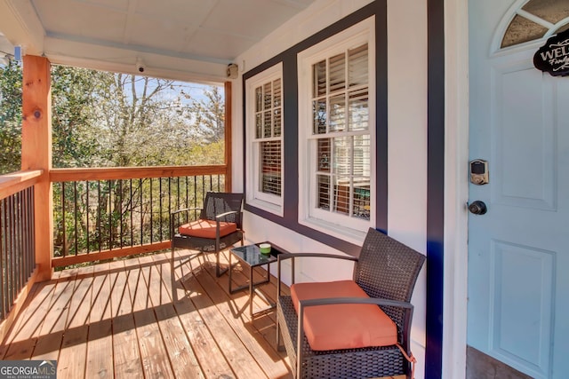 wooden terrace featuring covered porch