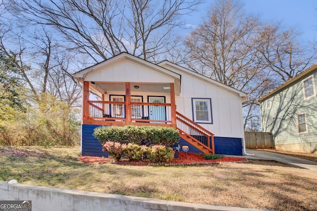 view of front of home featuring a front yard and a porch