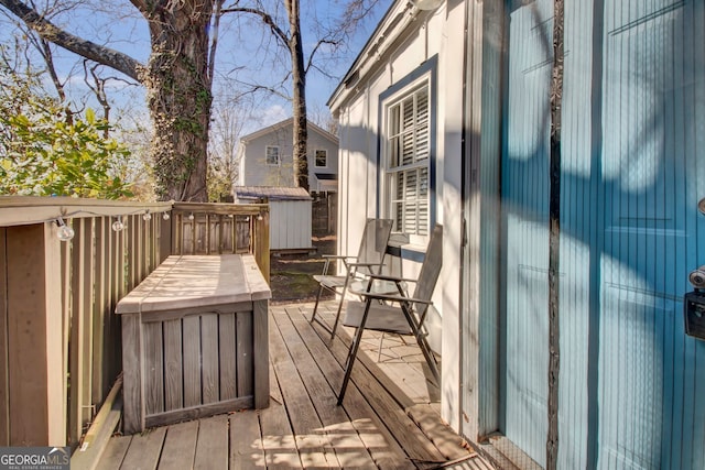 wooden terrace featuring a storage shed