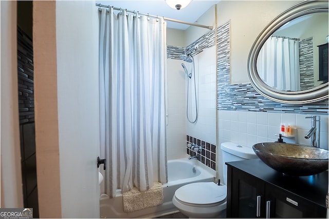 full bathroom featuring tile walls, backsplash, vanity, toilet, and shower / bath combo with shower curtain