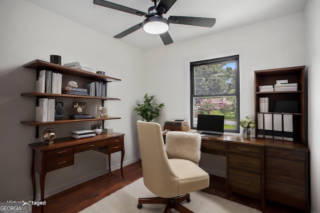 home office featuring dark hardwood / wood-style floors and ceiling fan