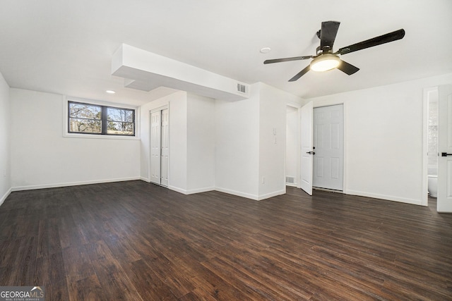 spare room with ceiling fan and dark hardwood / wood-style flooring