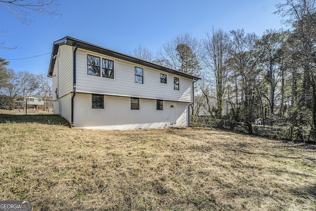 rear view of property with a yard