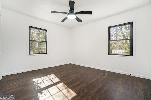 unfurnished room featuring ceiling fan and dark hardwood / wood-style floors