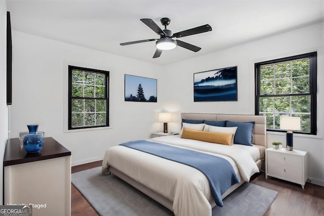 bedroom with dark wood-type flooring and ceiling fan