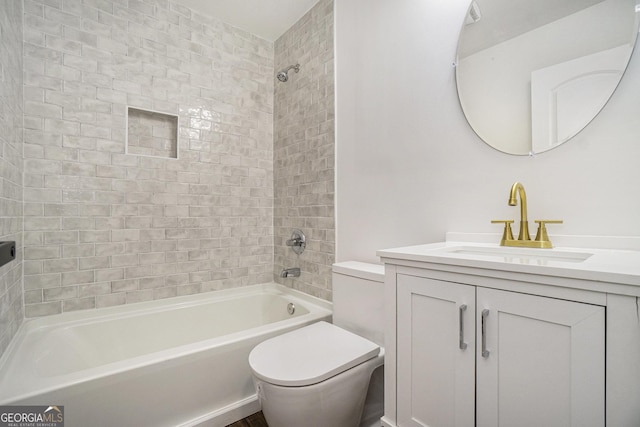 full bathroom with tiled shower / bath, vanity, and toilet