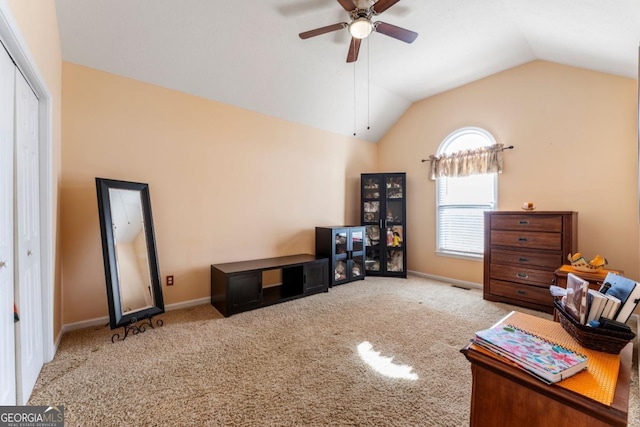 living room featuring ceiling fan, light colored carpet, and vaulted ceiling