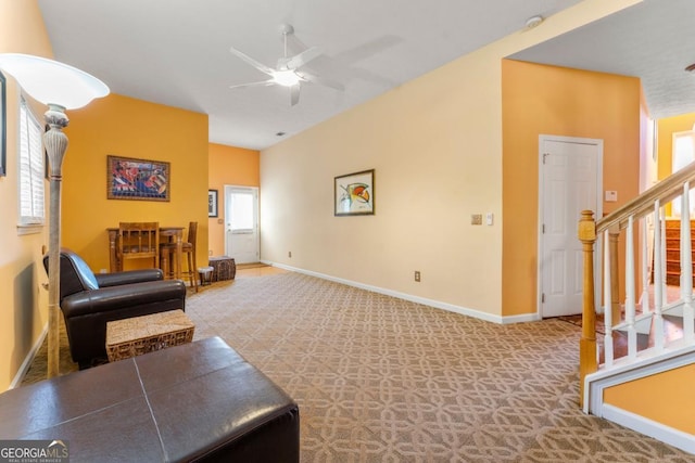 carpeted living room featuring ceiling fan