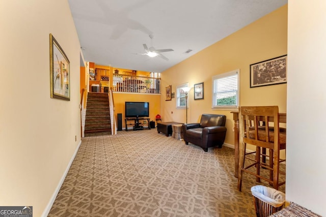 living room featuring carpet and ceiling fan