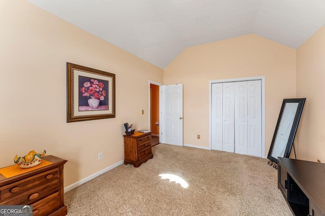 bedroom with vaulted ceiling, carpet, and a closet