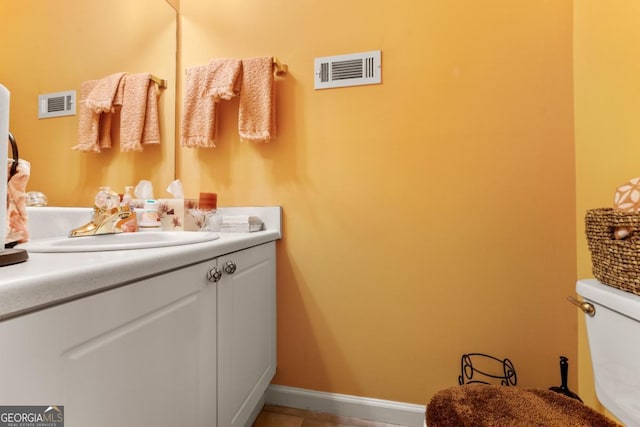 bathroom featuring vanity and toilet