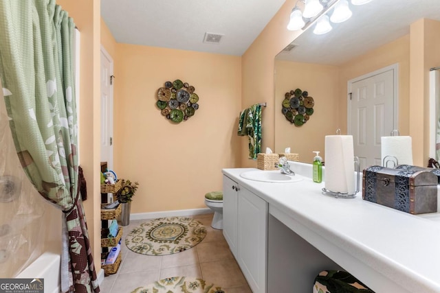 bathroom featuring vanity, tile patterned floors, and toilet