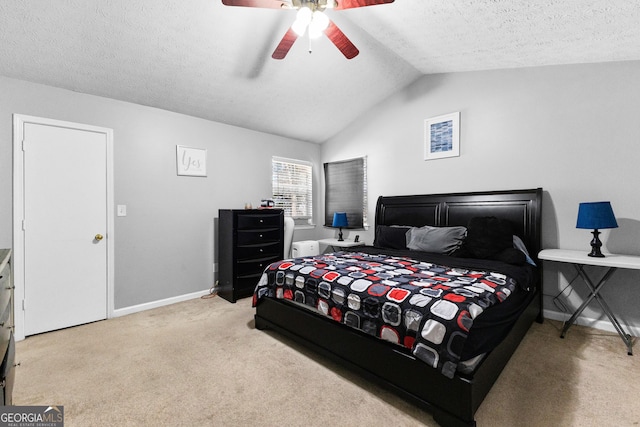 bedroom with light carpet, ceiling fan, vaulted ceiling, and a textured ceiling