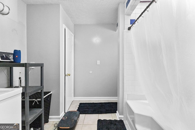 bathroom with shower / tub combo with curtain, tile patterned floors, and a textured ceiling