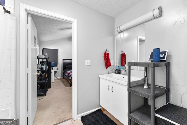 bathroom featuring vanity, a shower with curtain, and a textured ceiling