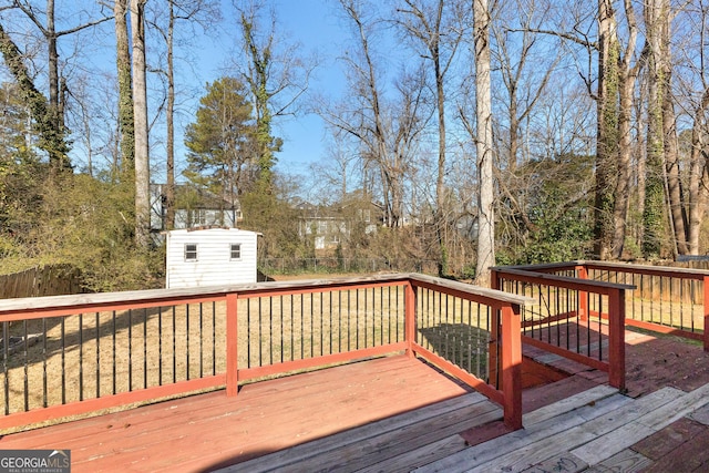 deck featuring a storage shed and a lawn