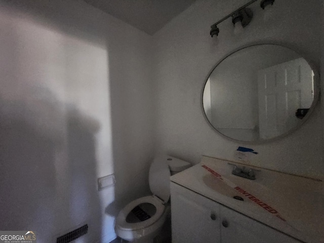 bathroom featuring vanity and toilet