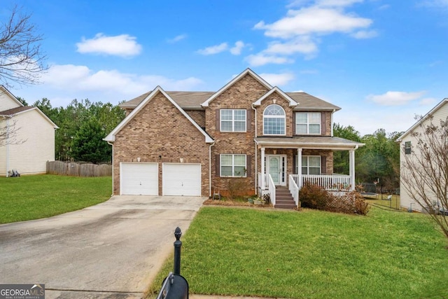 view of front of property with a garage, covered porch, and a front lawn