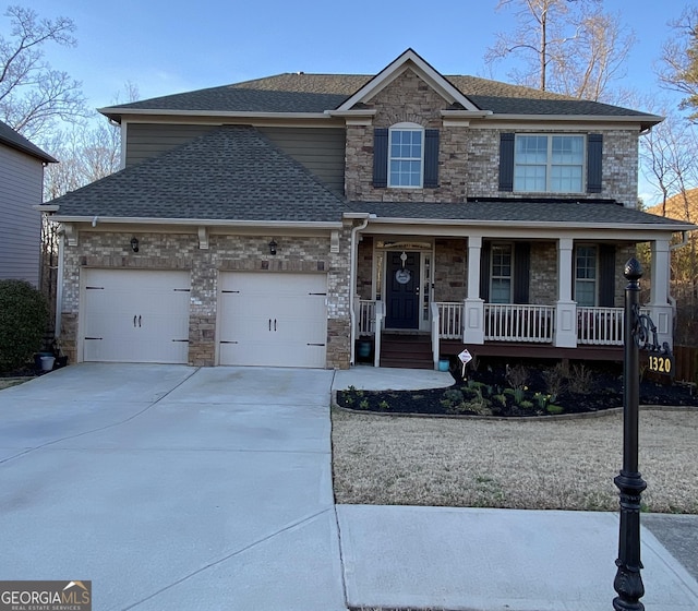 view of front of house featuring an attached garage, covered porch, a shingled roof, and concrete driveway