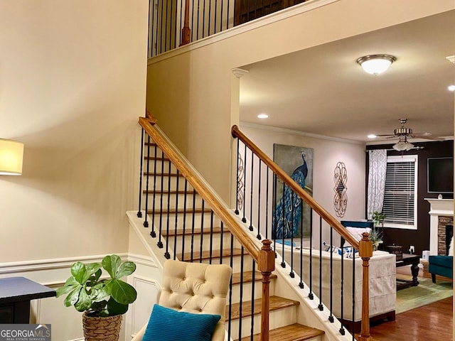 1320 Newbridge Cir, Buford, GA 30519 - stairs featuring ceiling fan, wood finished floors, recessed lighting, a fireplace, and crown molding