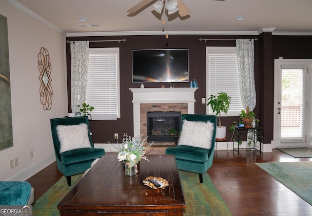 1320 Newbridge Cir, Buford, GA 30519 - living area featuring ceiling fan, wood finished floors, a stone fireplace, and ornamental molding