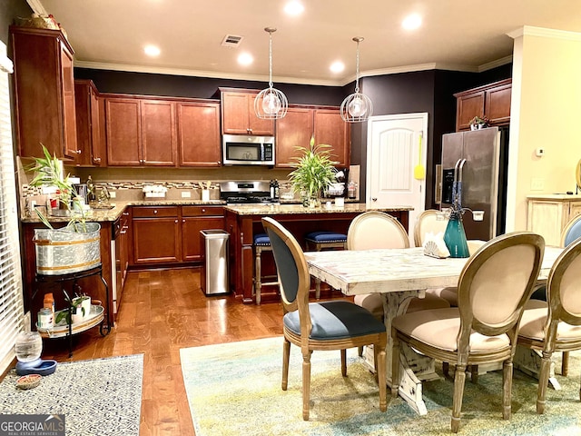 1320 Newbridge Cir, Buford, GA 30519 - kitchen with stainless steel appliances, decorative backsplash, an island with sink, hanging light fixtures, and light stone counters