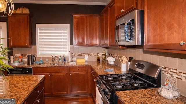 1320 Newbridge Cir, Buford, GA 30519 - kitchen featuring stainless steel appliances, backsplash, dark stone countertops, crown molding, and wood finished floors