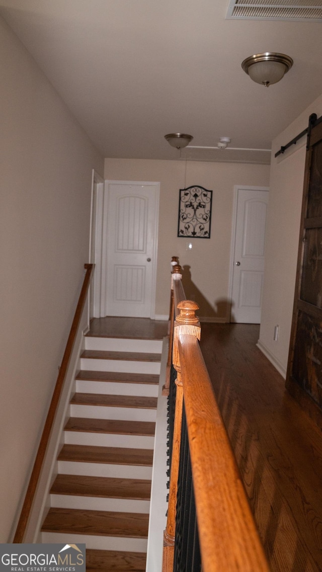 1320 Newbridge Cir, Buford, GA 30519 - stairs featuring a barn door and wood finished floors