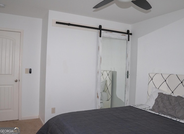 1320 Newbridge Cir, Buford, GA 30519 - carpeted bedroom with a barn door and ceiling fan