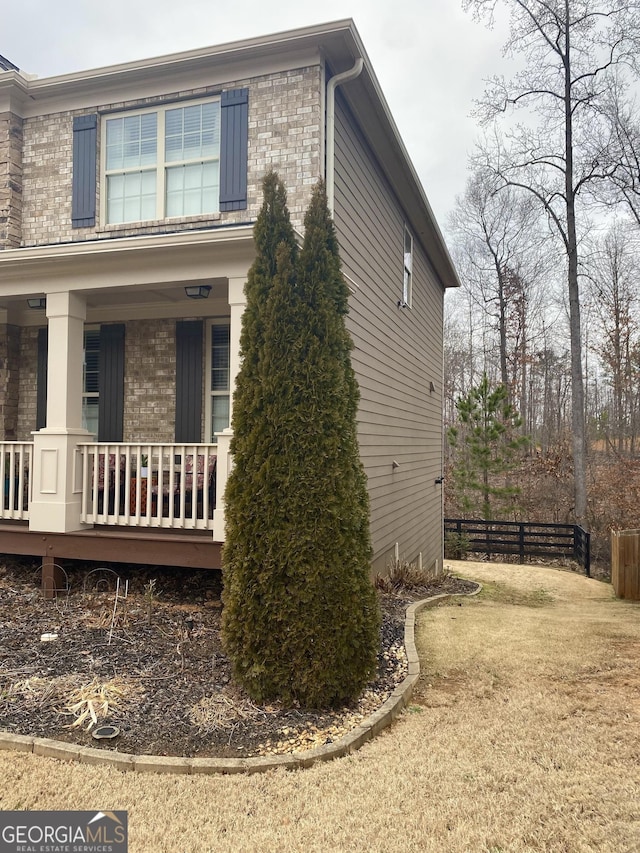 1320 Newbridge Cir, Buford, GA 30519 - view of property exterior with covered porch and brick siding