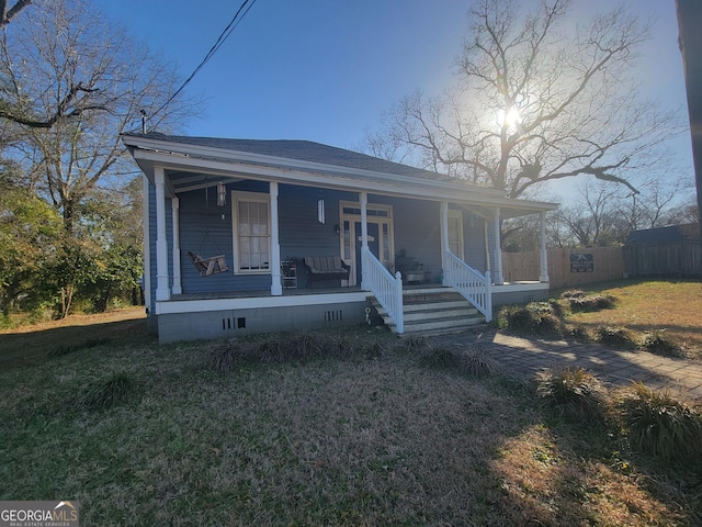 view of front of property with a porch and a front yard