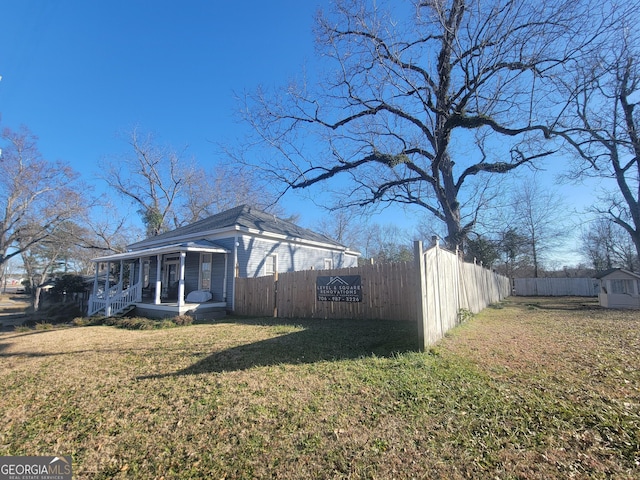 view of home's exterior featuring a lawn and a porch