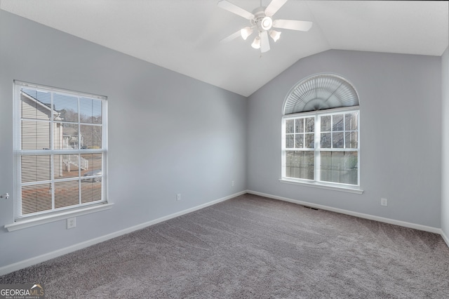 carpeted spare room featuring lofted ceiling and ceiling fan