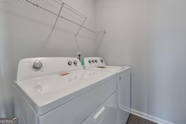 laundry room featuring dark hardwood / wood-style flooring and washing machine and clothes dryer